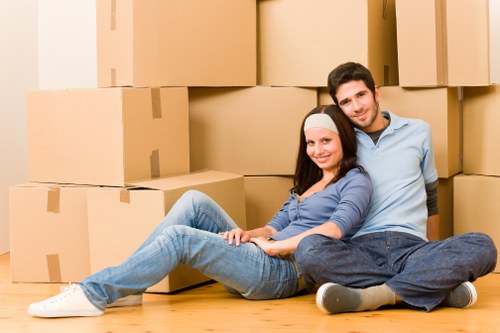 Packed moving boxes and wrapped furniture prepared for a house relocation in Wandsworth