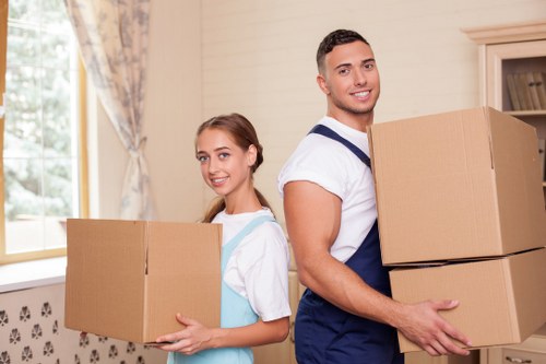 Local house removal team handling fragile household items carefully